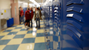 Hallway in high school with lockers and students talking