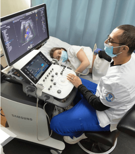 Two sonography students in lab, running vascular sonography exam